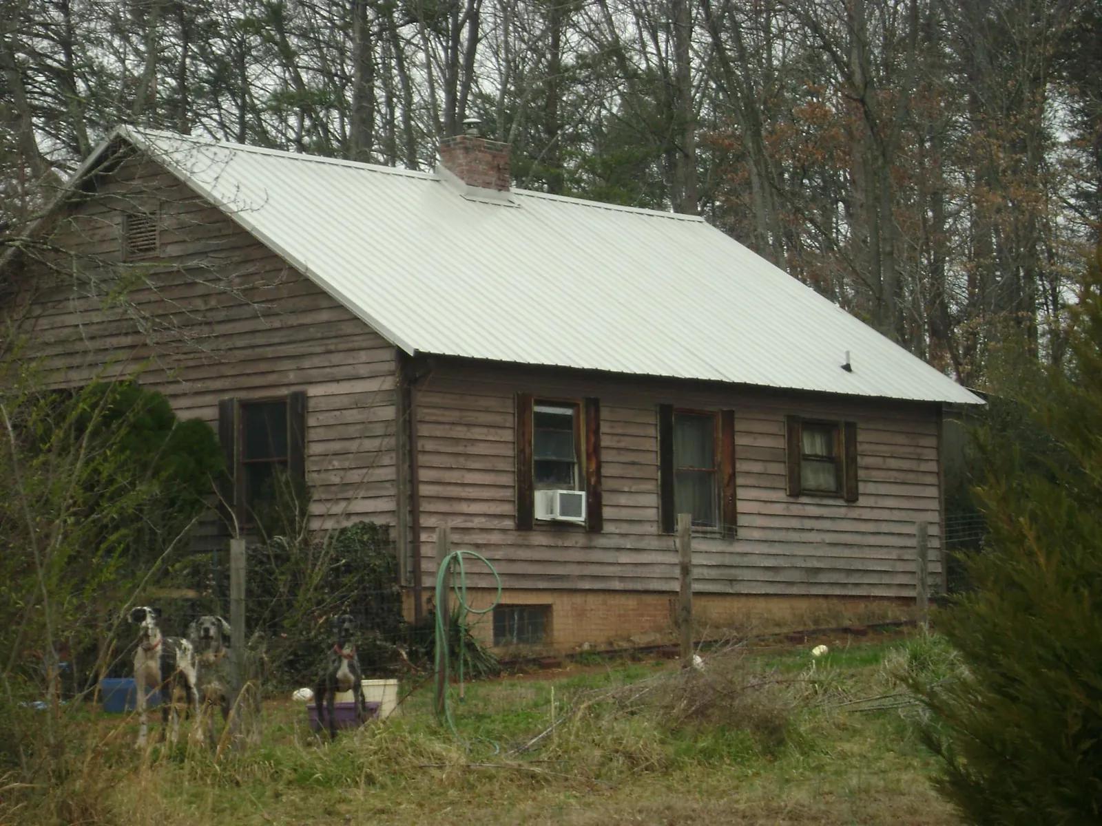 White metal roof on an old wood sided farmhouse, from a Metal Roof Installation job in King